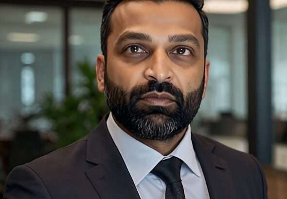 Kash Patel as Director of the FBI, wearing a dark suit and tie, standing in a professional office environment with a focused expression, symbolizing leadership and authority."